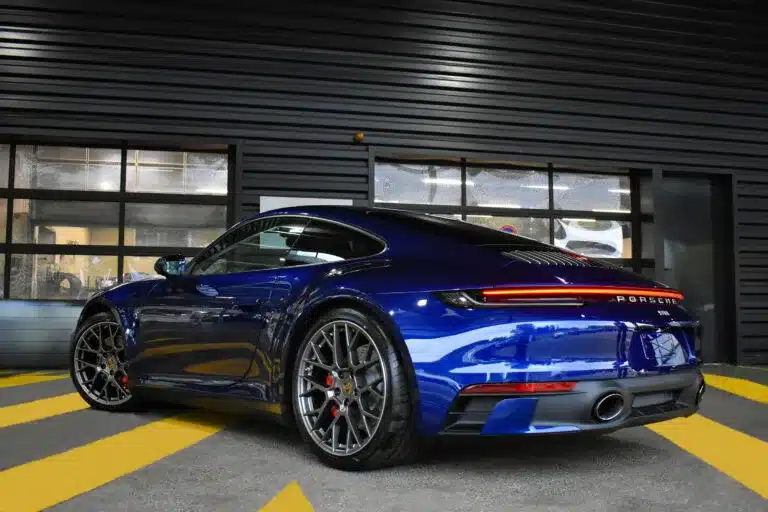 Dark blue Porsche in garage with premium Paint Protection Film for Cars, showcasing its sleek design and enhanced durability